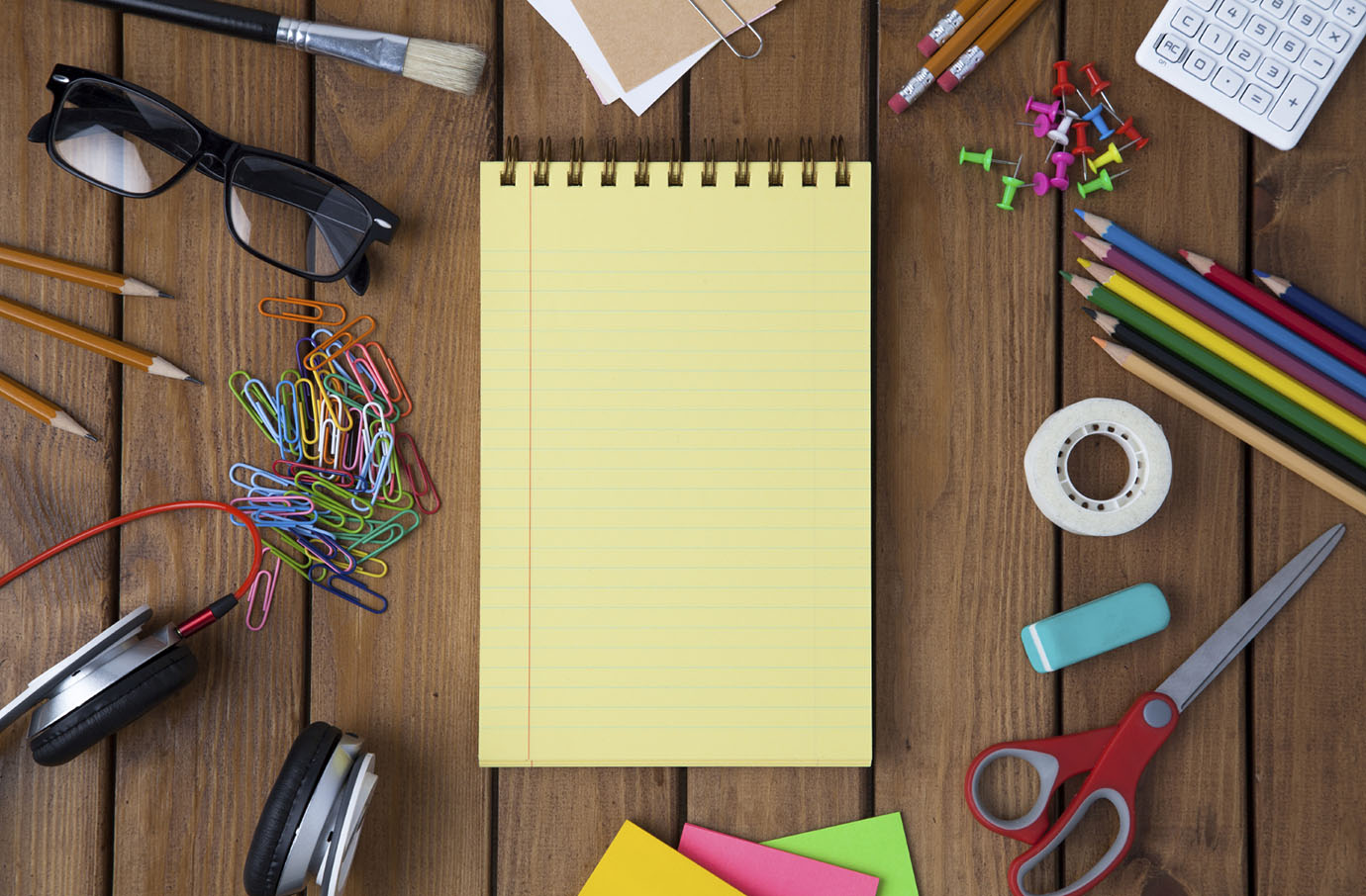 Miscellaneous office material on wooden background, directly above shot